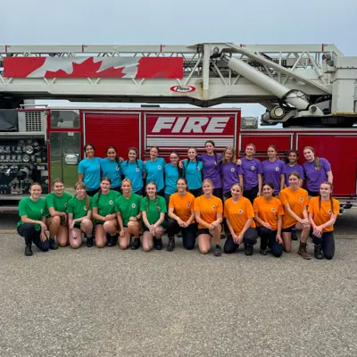 Participants in the female fire fighters in training program posing for a photo 