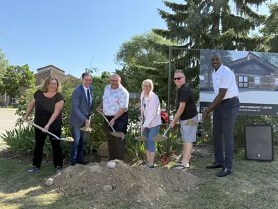 Mayor and councillors posing for photo op with shovels and dirt