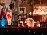 Vendor booth displaying decorative plates, felt snowmen and gnomes
