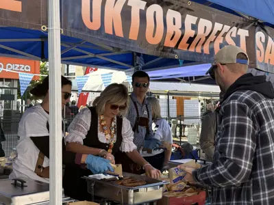city council staff serving sausages at oktoberfest