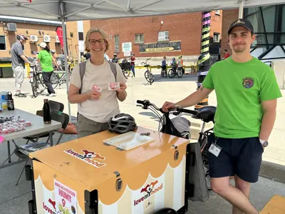 Councillor posing with bike serving ice cream