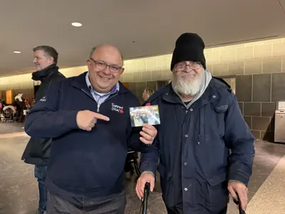 Mayor and old man posing with old photo