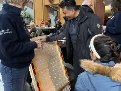 Members of council playing plinko at public event
