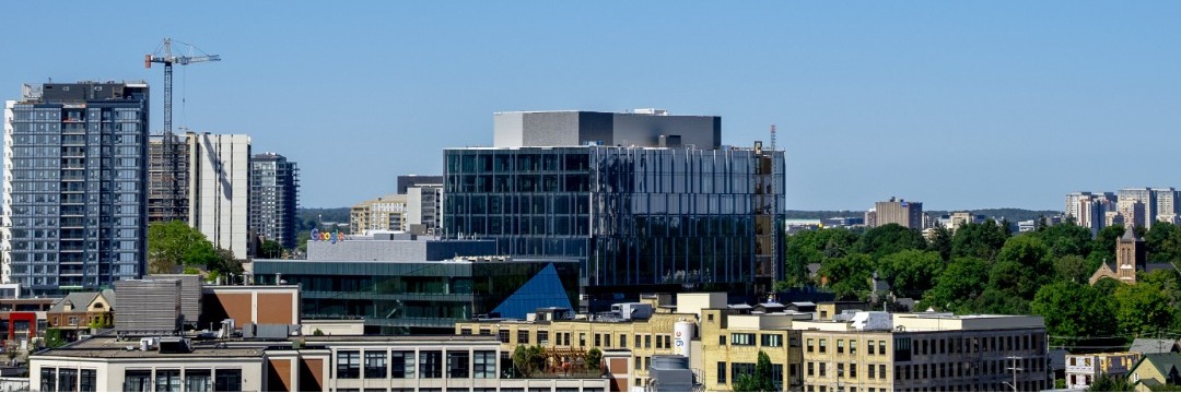 Aerial shot of downtown Kitchener showing a variety of buildings and a crane in the distance