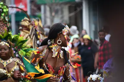 Revellers in colourful costumes walking down King Street