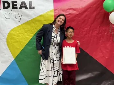 Councillor posing for photo with youth at photo op