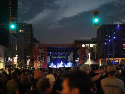 View of crowd looking at stage at outdoor concert