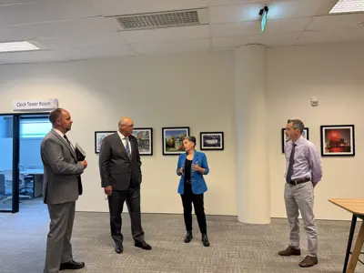Mayor, councillors and staff standing in office conversing