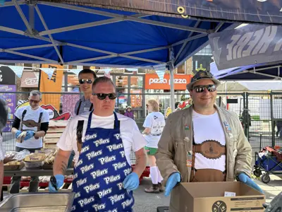 Councillors serving sausages at Oktoberfest