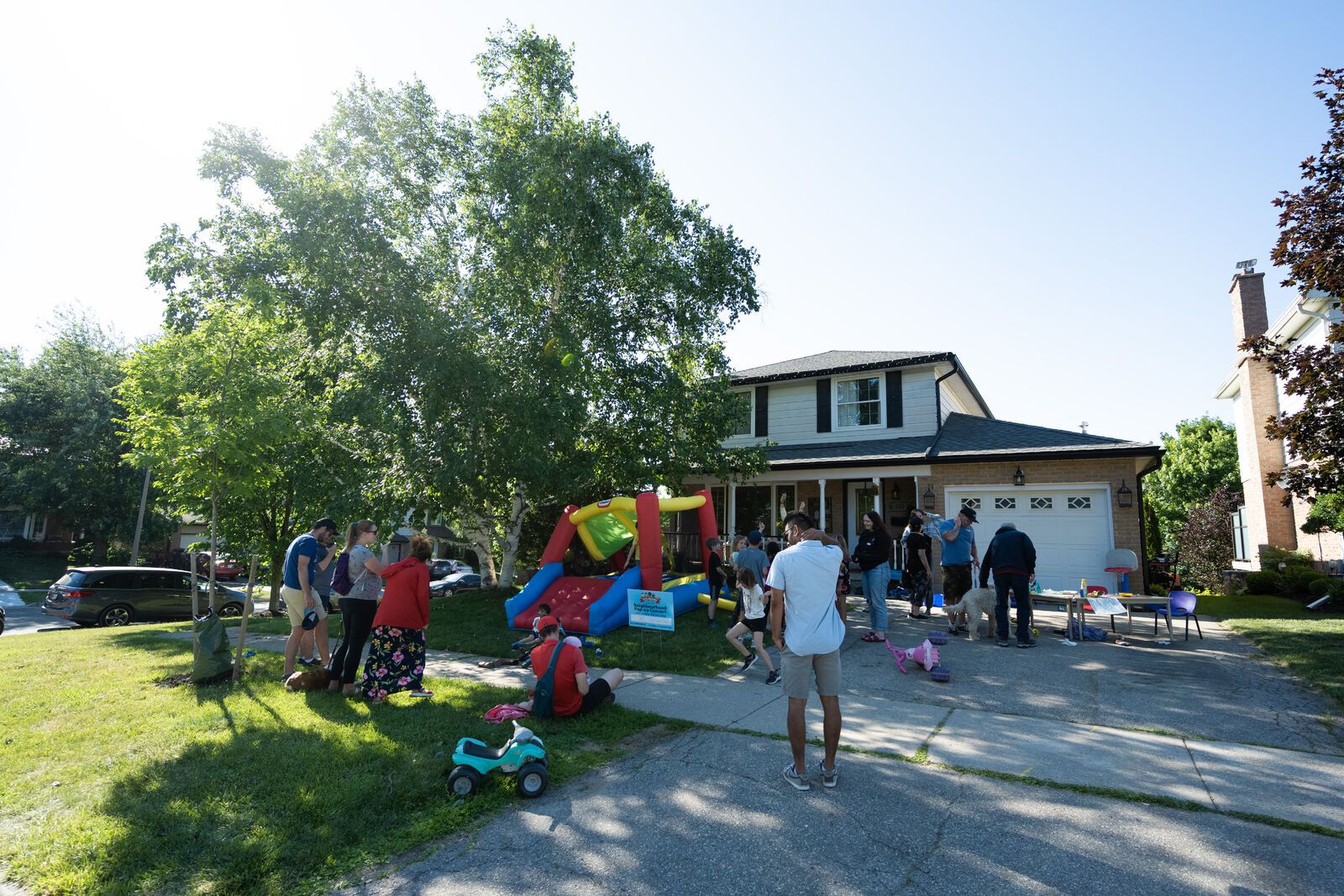 People gathered on a driveway for a street party