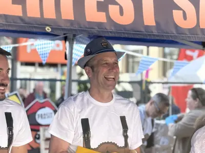 Councillor Schnider serving sausages at oktoberfest