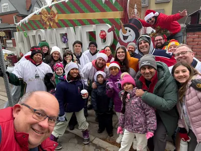People posing for group photo and smiling