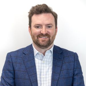 Man in a suit looking at the camera on a white background