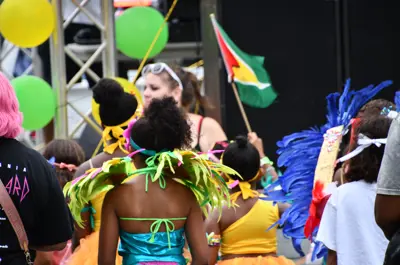 Revellers in colourful costumes walking down King Street