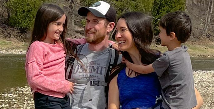Family standing by river