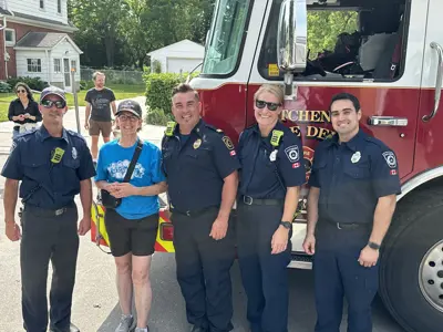 Councillor posing with fire fighters in front of fire truck